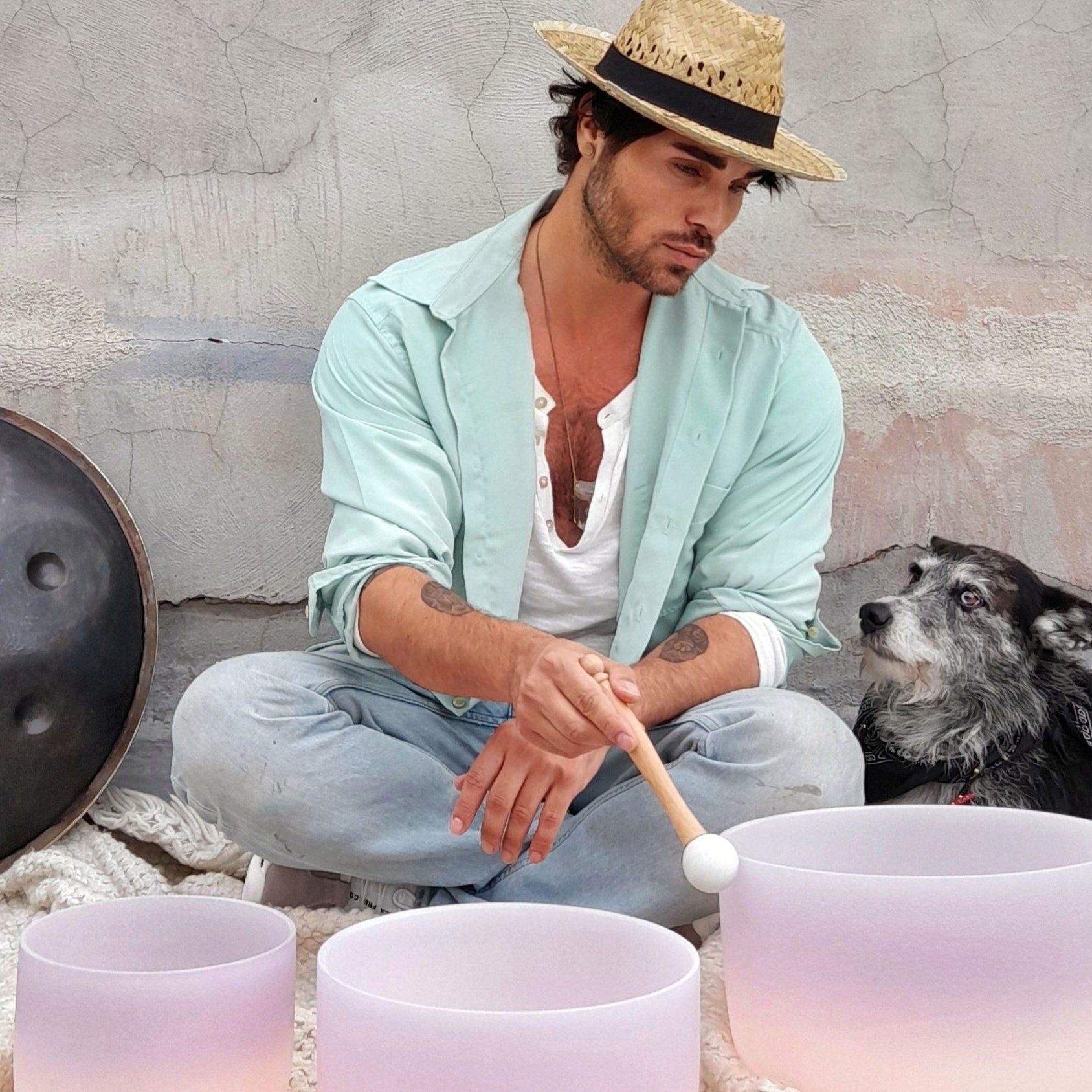 Man playing a Set of Driven by the Moon Cosmic Sound Bowls