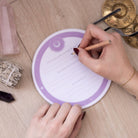 Hand writing on a Cosmic Sound Bowls® - Mindful Notepads