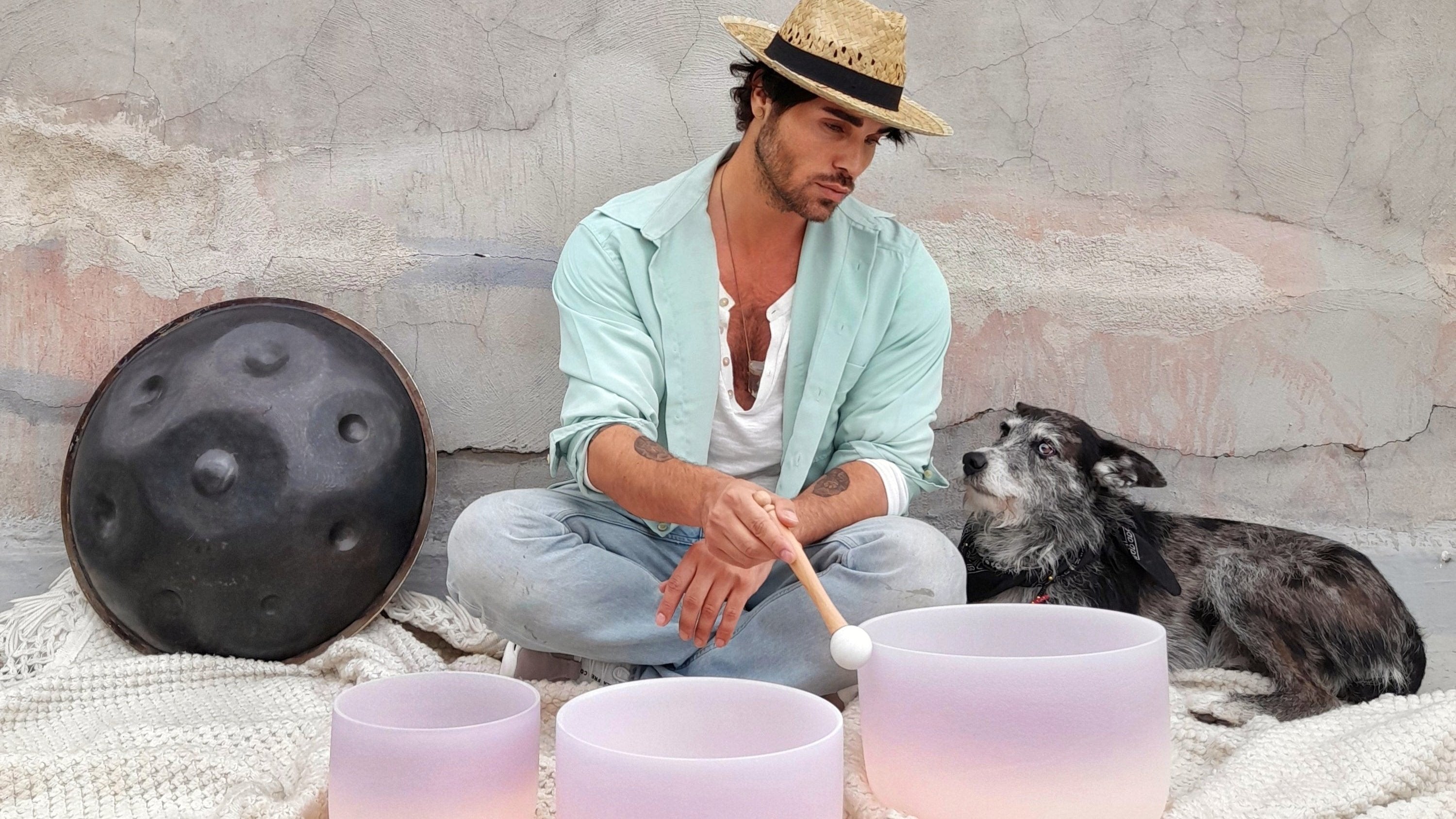 Man playing a Set of Driven by the Moon Cosmic Sound Bowls